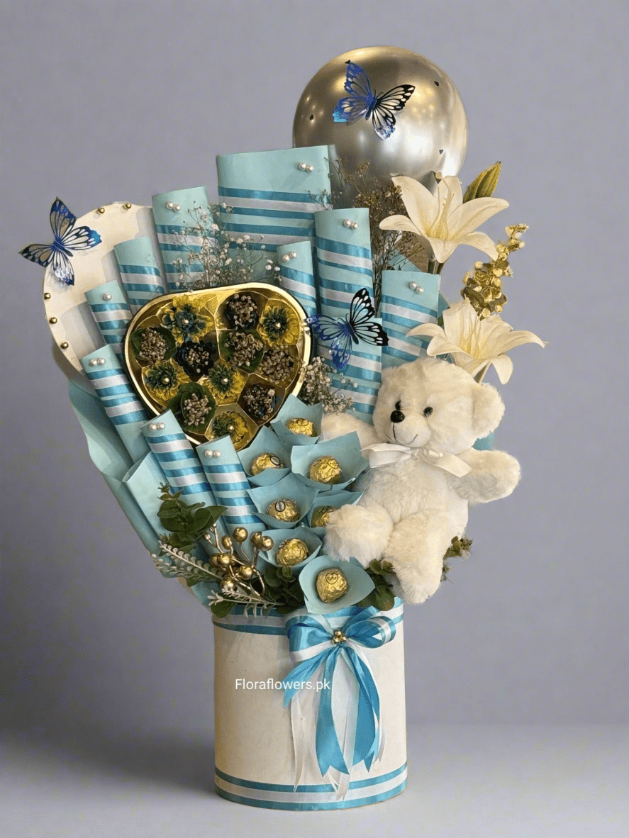 A bouquet arrangement composed of various chocolates including Snickers, Mars, KitKat, Dairy Milk, a wafer, and Ferrero Rocher, adorned with blue ribbons and decorative elements, and accompanied by a small teddy bear. Send flowers to islamabad. send flowers to pakistan
